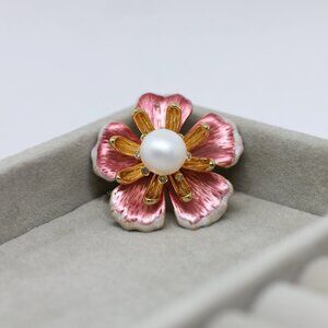 Elegant pink and gold flower pin with a pearl center
